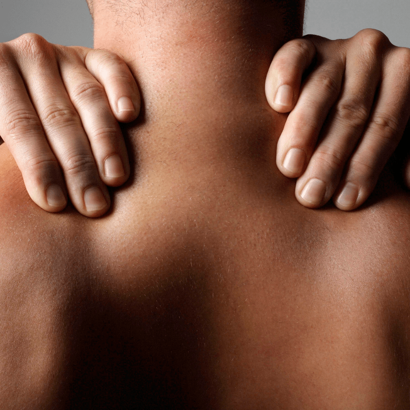 image of man's back and neck, with hands massaging shoulders